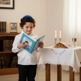 Boy with First Siddur at Shabbat table