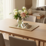 Gold mirror tray with flowers on dining table