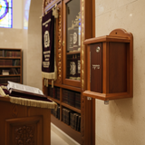 Wall-mounted tzedakah box in synagogue