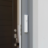 White mezuzah case on doorframe