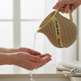 Beige Washing Cup with Hebrew Text - Netilat Yadayim in Use