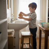 Child with 4 pastel cups