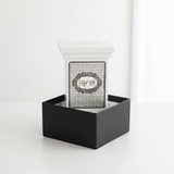 Elegant white tzedakah box with natural lighting