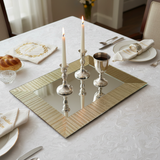 Gold mirror tray with Shabbat candles and Kiddush cup