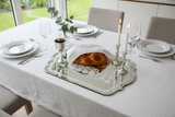 Overhead view of Shabbat mirror tray on dining table